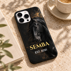 Coque cheval noir SEMBA posée sur une table en pierre claire, près d’un carnet et d’un café.